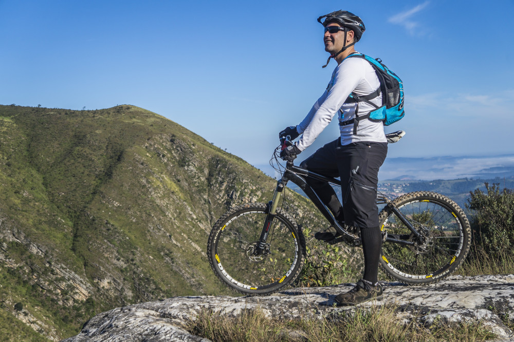 man with white shirt riding abicycle on a mountain 163491